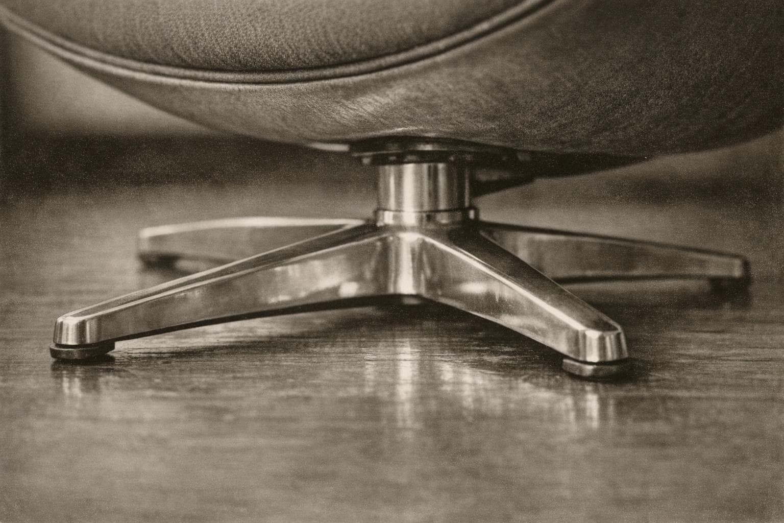Close-up of a polished four-pointed aluminium chair base